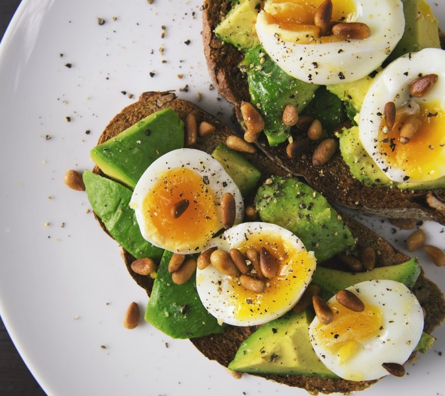 a plate of pastry with avocados and boiled eggs